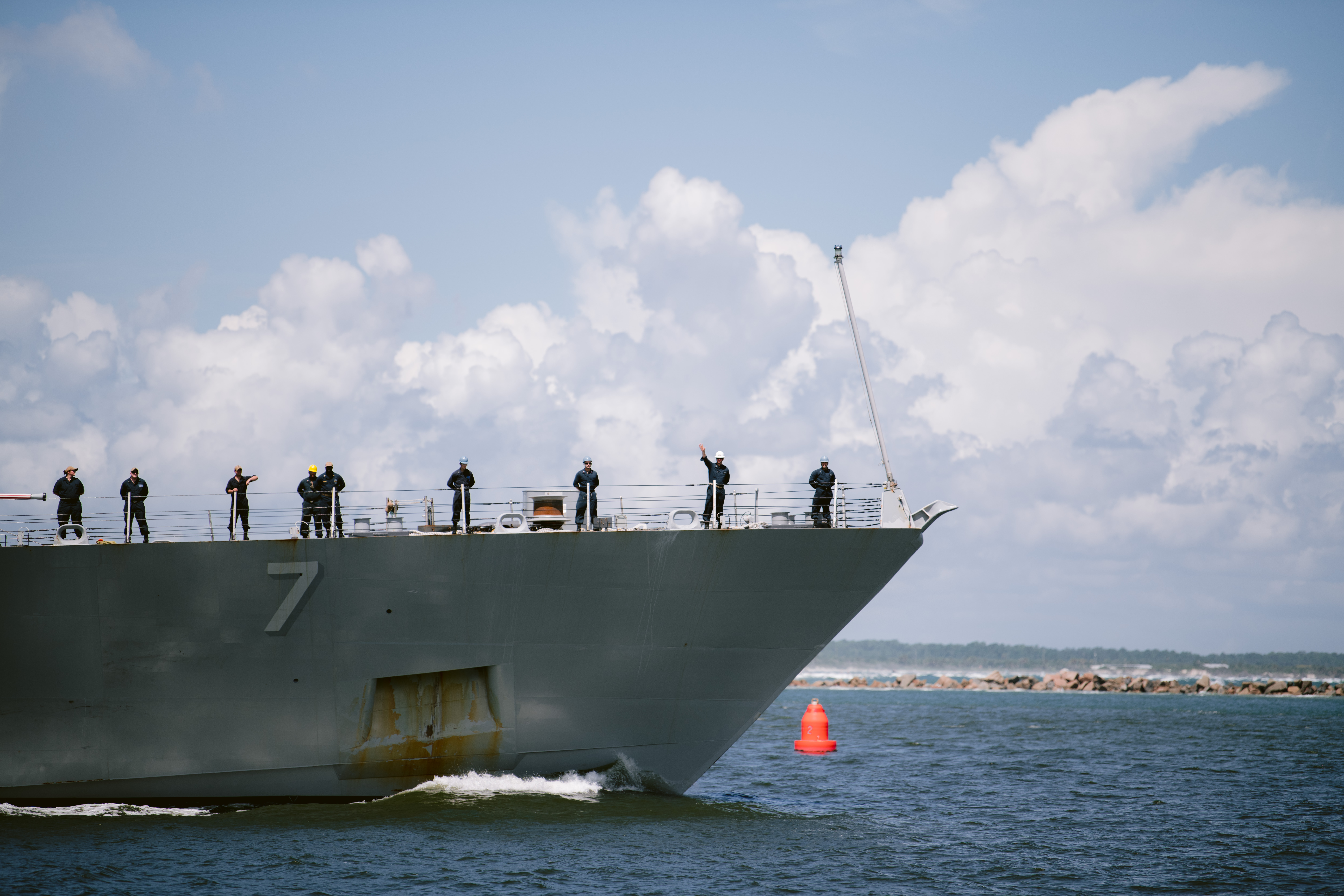 sailor waves farewell during deployment