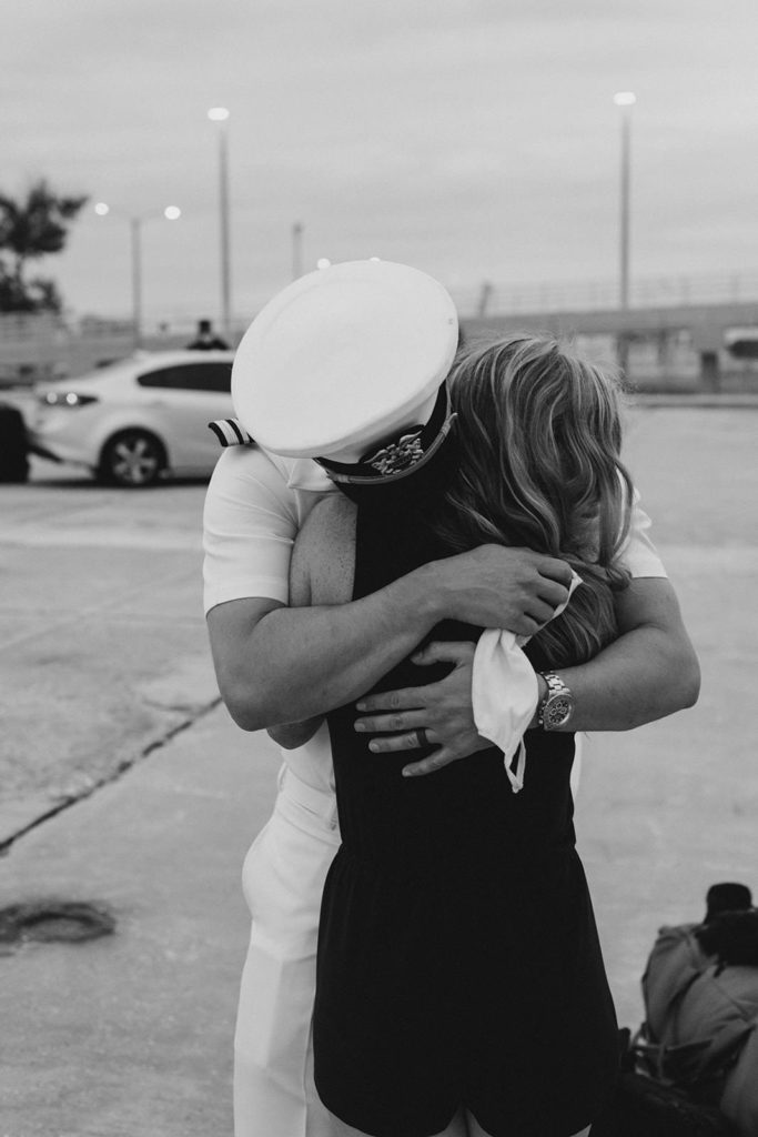 Couples embrace during a covid19 military homecoming san diego