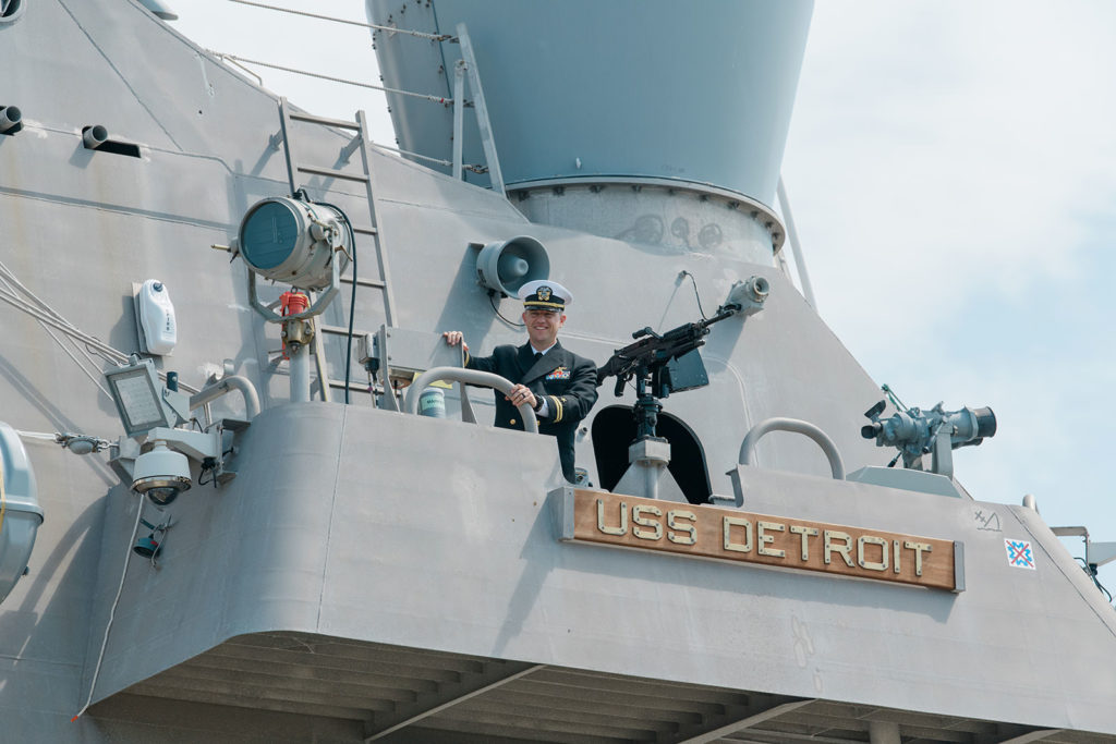 navy officer waves to family during deployment
